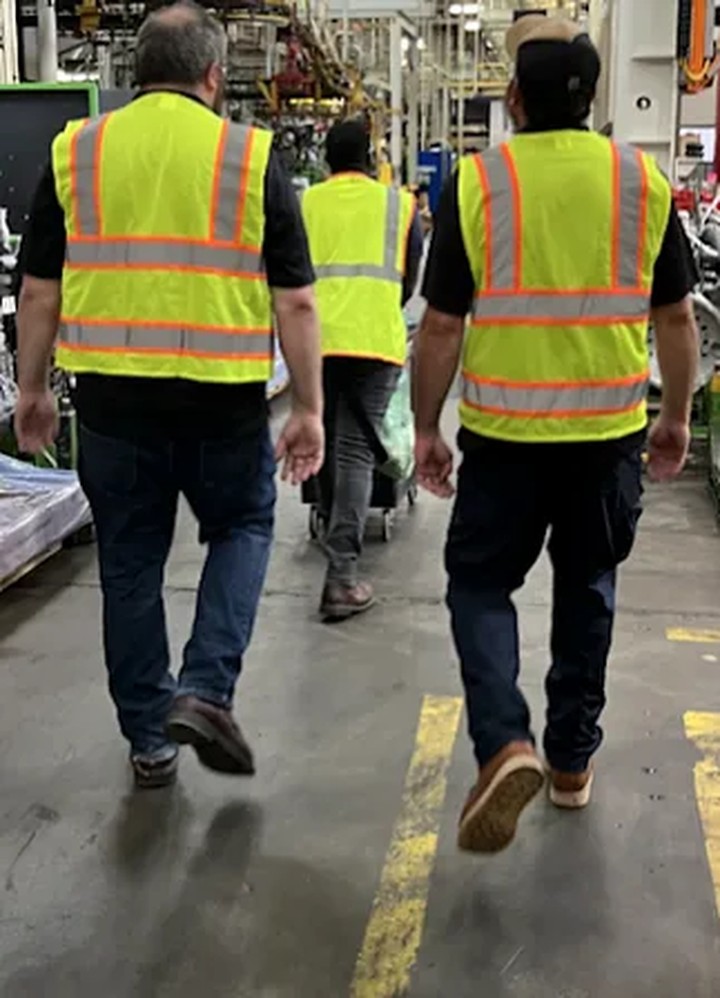 LOTO compliance professionals performing on-site lockout tagout work in a manufacturing facility
